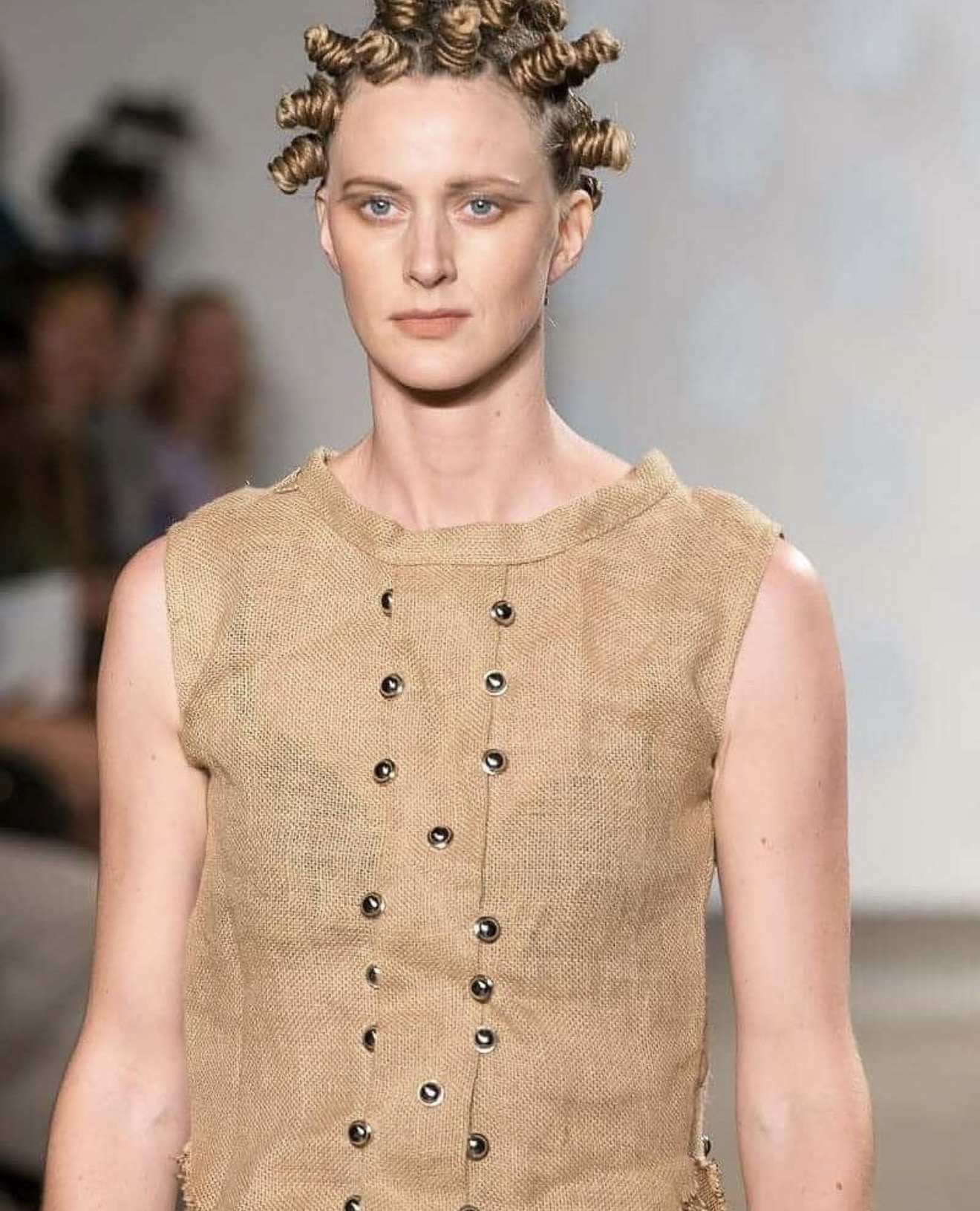 Close-up of female model in sleeveless sisal sack vest dress with grommet details — womenswear