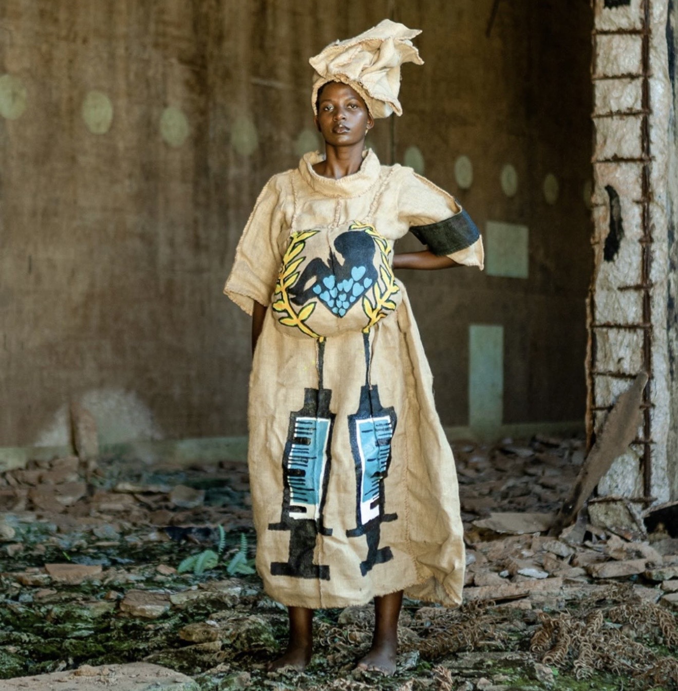 Bobbin Case male model in long sisal sack robe with scattered metal stud pattern on runway