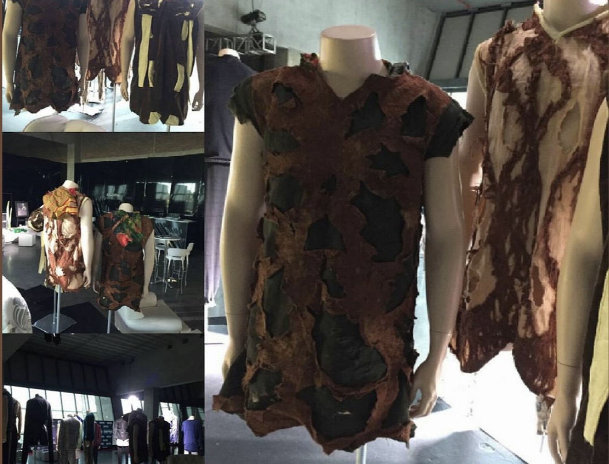 Bobbin Case exhibition — recycled and upcycled fabric garments displayed on mannequins in an exhibition space, showing the range of Bobbin Case's sustainable material work